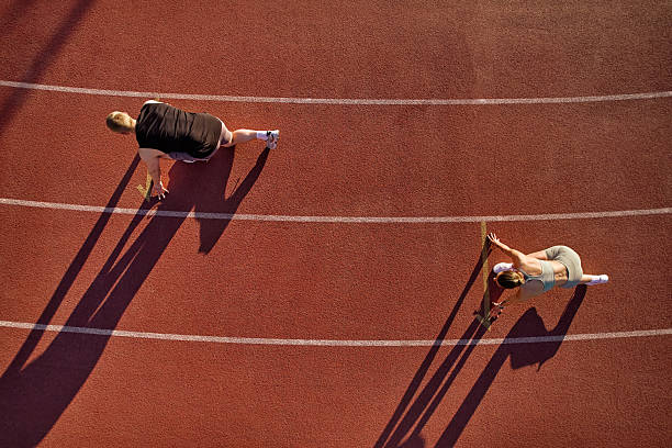 istock Two athletes in starting position on running track, aerial view 2224298123