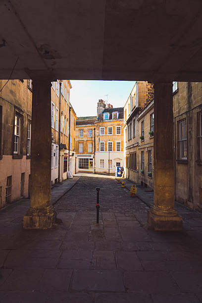istock Columns framing a narrow street in bath, england 2224298395