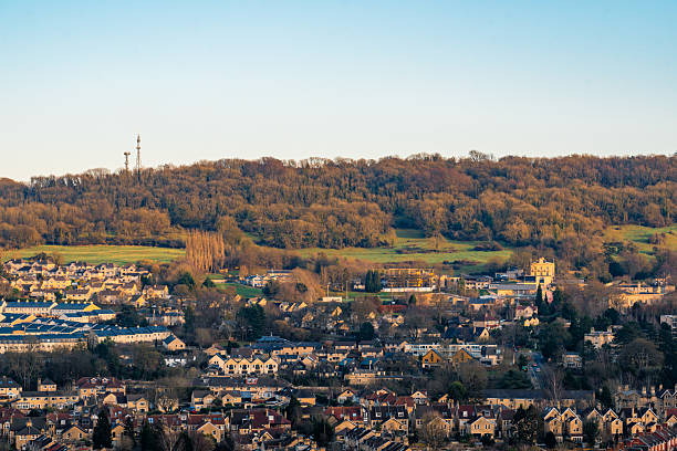 Skyline of bath, england, featuring residential houses, a transmitter tower, and a beautiful hillside landscape
