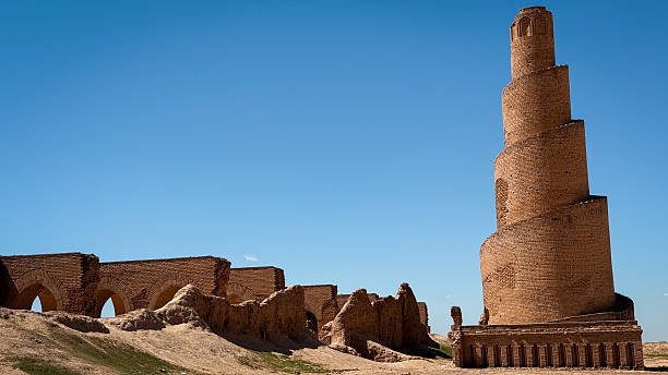 istock Historic minaret base in Iraq showcasing ancient architecture under clear blue sky 2224300723