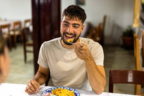 istock Young Man Eating Breakfast with Girlfriend at Cozy Table 2224301929