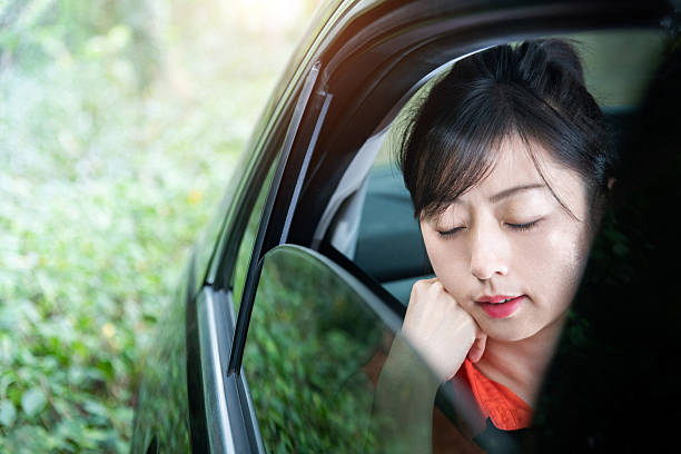 istock Beautiful woman sleeping in a car 2224301964
