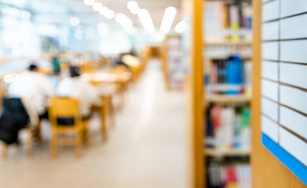 Blur library with book shelves and people