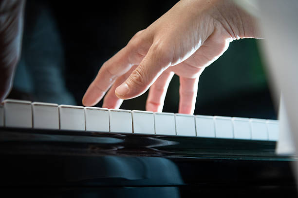 istock Woman's hands playing the piano 2224303519