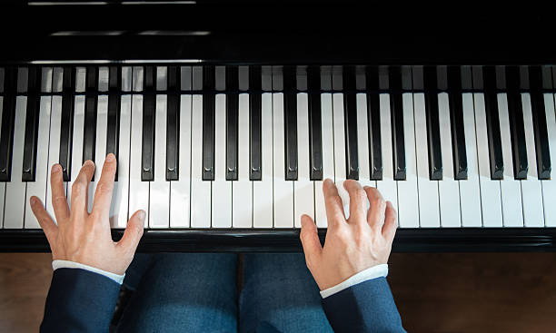 istock Woman's hands playing the piano 2224303541
