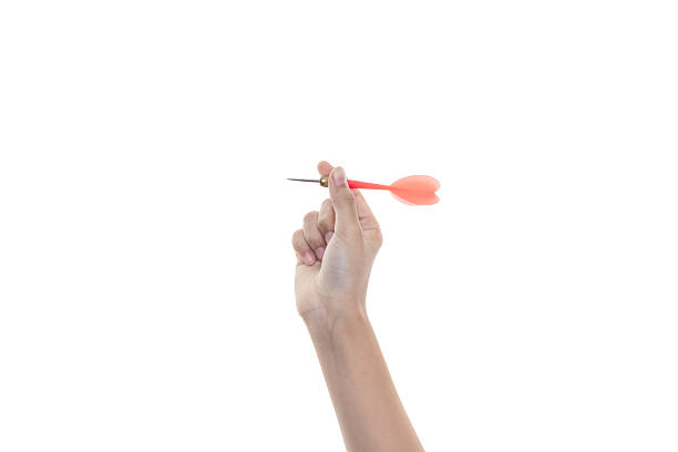 istock Female hand holding a red plastic dart, ready for a game or to aim at a target. The object is isolated on white background with clipping path. 2224304285