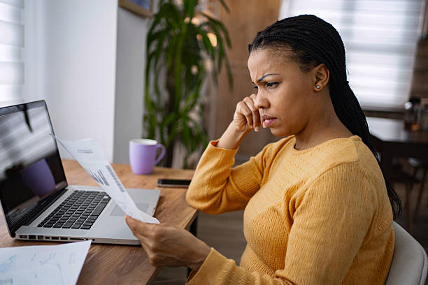 istock Stressed young woman reading a document with bad news at home office 2224306784