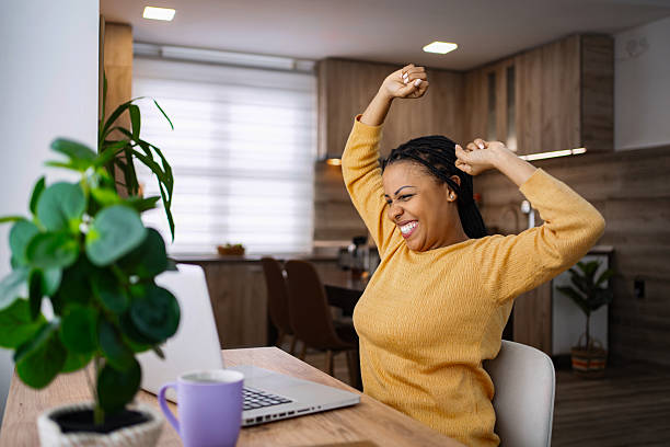 istock Excited young woman celebrating success working from home 2224306790