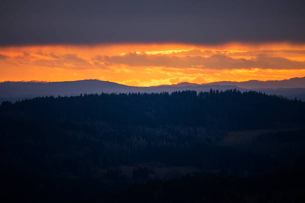 istock Vibrant orange sunset illuminating rolling hills and forests in Czech Republic 2224307779