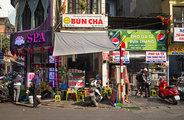 People browse small restaurants and shops in the Old Quarter, Hanoi, Vietnam.