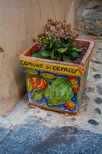 Narrow streets and Stairways with ceramic pots in Cefalu, Sicily, Italy