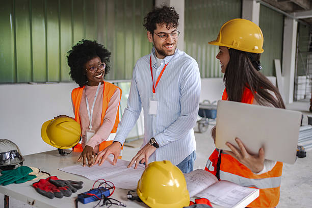 istock Architects and engineers discussing blueprint of new building 2224308907