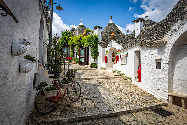 Scenic view of one of the famous streets of Alberobello and its houses, a UNESCO World Heritage site. Photo taken on 21st of June 2025 in Alberobello, a small town of the Metropolitan City of Bari, Apulia, southern Italy.
