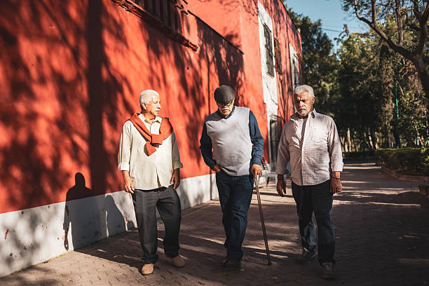 istock Three senior men walking and chatting in the city 2224311448