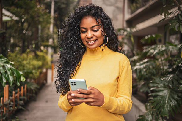 istock Young adult using smartphone outdoors in urban setting 2224311596
