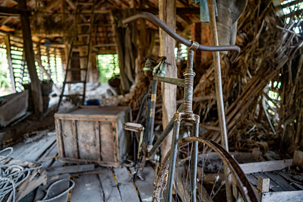 Vintage wooden bicycle leaning against white wall
