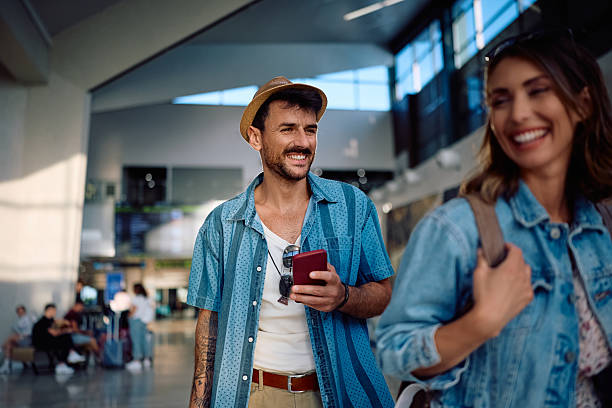 istock Happy man using smart phone at the airport. 2224312441