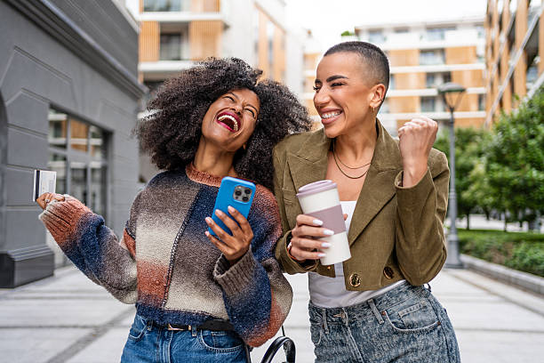 istock Joyful young adults celebrating in urban setting 2224312680