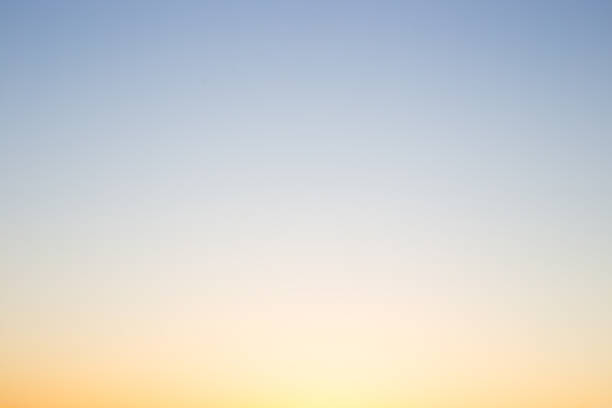 istock The gradient of the sky at sunset changes from yellow to soft blue, capturing a moment of natural beauty 2224313358