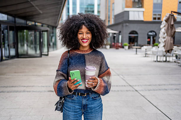 istock Young woman enjoying coffee in urban setting 2224313466
