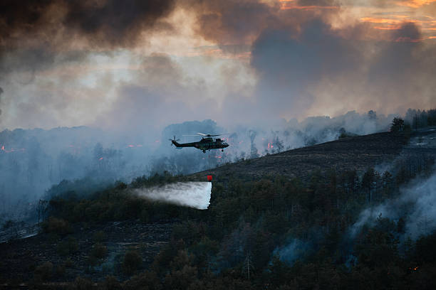 istock Helicopter dumping water on a wildfire 2224314025