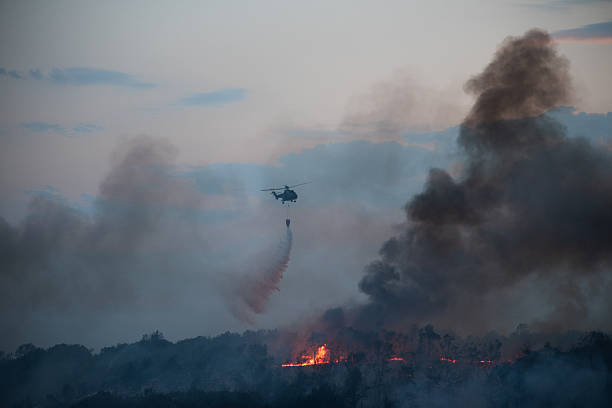 istock Helicopter dumping water on a wildfire 2224314038