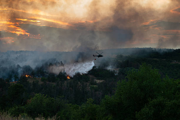 istock Helicopter dumping water on a wildfire 2224314139
