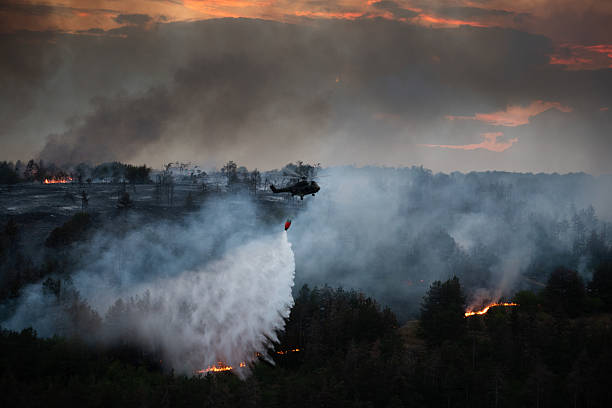 istock Helicopter dumping water on a wildfire 2224314373