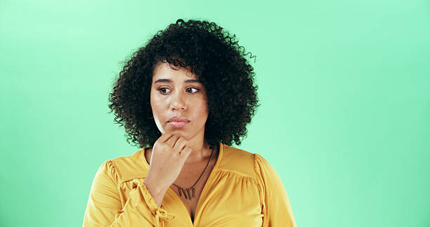 istock Thinking, ideas and woman in studio for decision, planning or brainstorming for education lesson. Solution, question and female teacher with choice for career by green background with mockup space. 2224316997