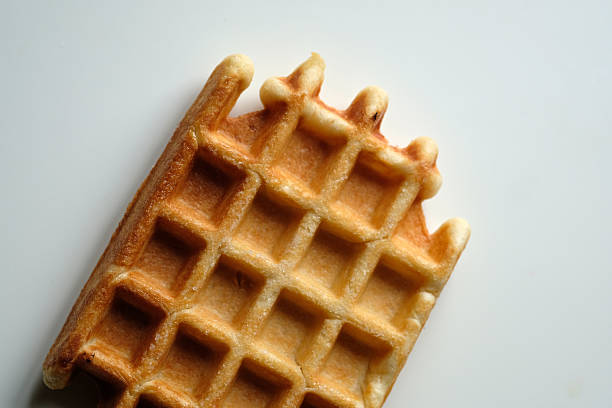 istock Golden crispy waffle displayed on a clean white surface, perfect for breakfast or dessert enjoyment 2224318425