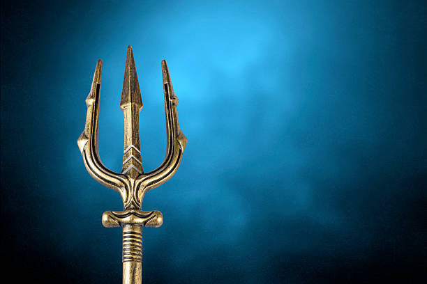 Golden trident over blue misty background