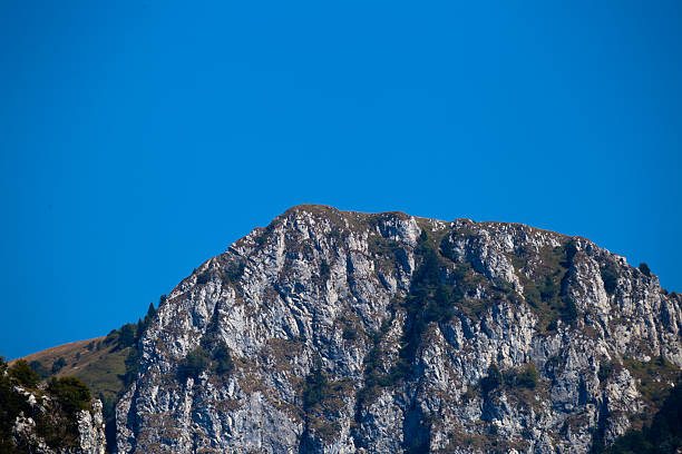 Majestic Rocky Mountain Peak With a Clear Blue Sky Background