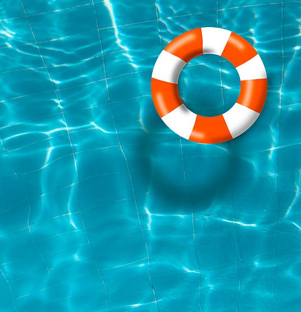 istock Orange and white pool float, top view of orange float in a refreshing blue swimming pool, ring float on a top of vibrant blue water surface. 2224325554