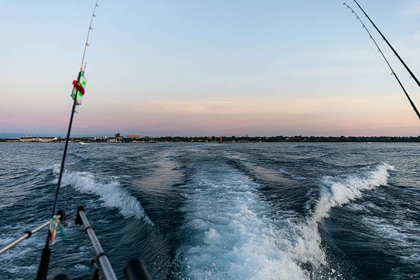 istock Fishing rods and waves at sunset. 2224327895