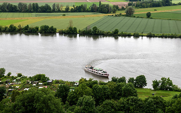 Regensburg, Germany, June 7, 2025: A cruise ship sails on the Danube River near the Bavarian town of Regensburg on a spring day.