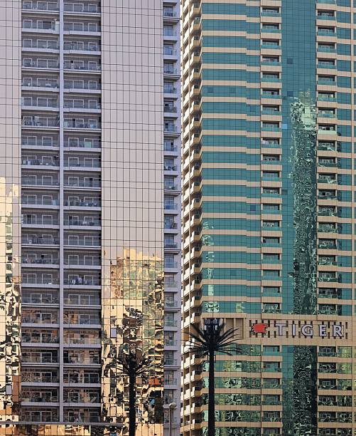 Dubai, United Arab Emirates – March 02, 2025: Modern skyscrapers with reflective glass facades under clear skies.