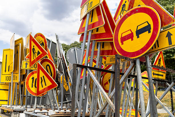 istock Collection of traffic signs stacked at a construction site during daylight hours 2224329408