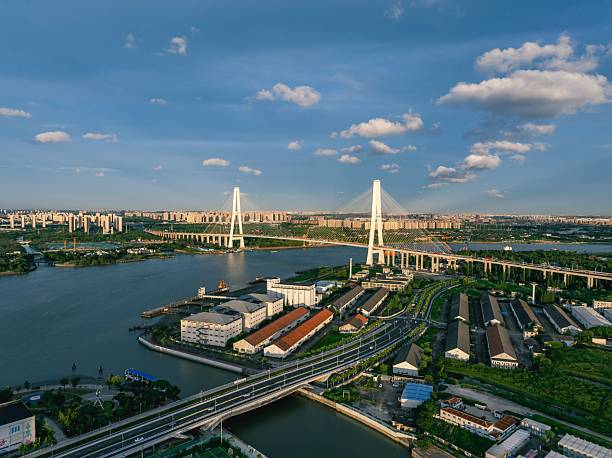 istock Aerial view of a modern cable-stayed bridge with urban skyline. 2224330425