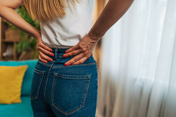 istock Woman experiencing back pain at home 2224330450