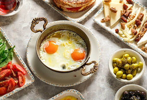 istock Turkish breakfast fried eggs with green olives, tomato paste, jam and butter 2224335199