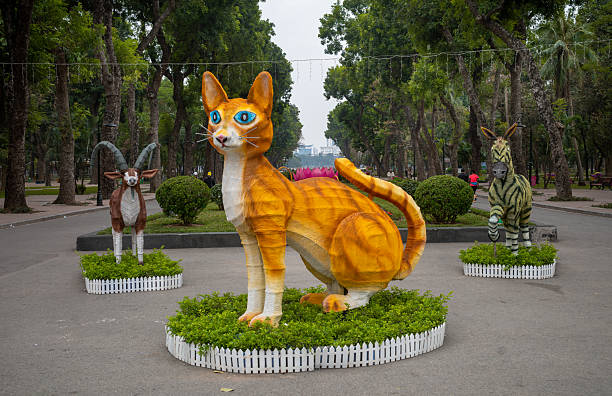 A large yellow model cat with blue eyes on display in Reunification Park in Hanoi, Vietnam, to welcome the lunar new year of the cat in January 2023