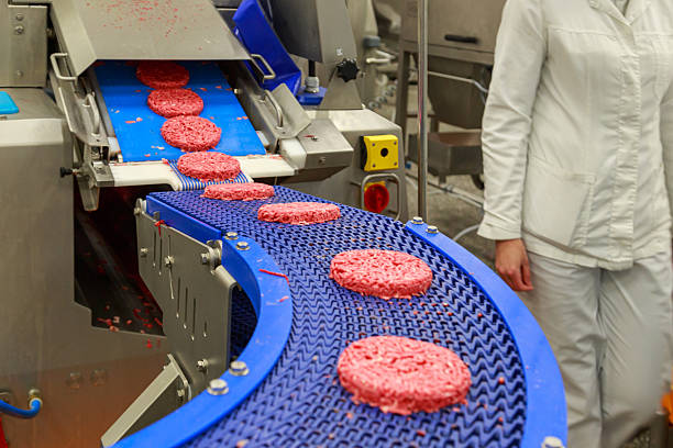 istock Conveyor machine with burgers from pure beef. 2224340253