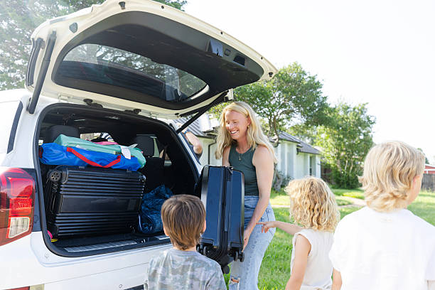 istock Family Packing Car for Vacation, Loading Luggage 2224340926