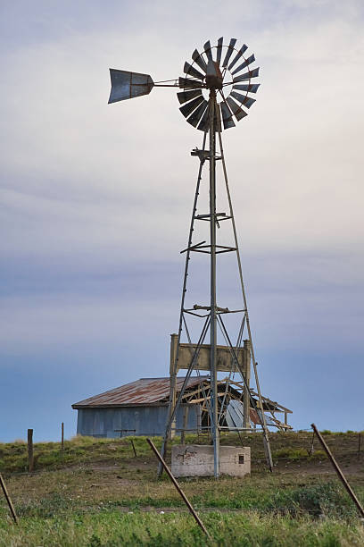 istock Old windmill standing tall over abandoned farm in rural landscape 2224342862