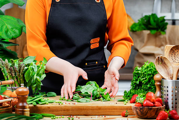 istock Cooking fresh vegan dishes with vibrant vegetables, chard and herbs in a modern kitchen environment 2224343253
