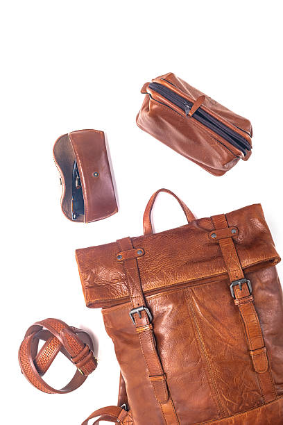istock Modern leather backpack and accessories on a white background. Stylish leather accessories close-up. View from above. 2224344472