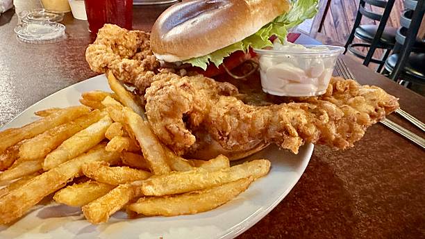 A giant Hoosier Tenderloin sandwich with fries.