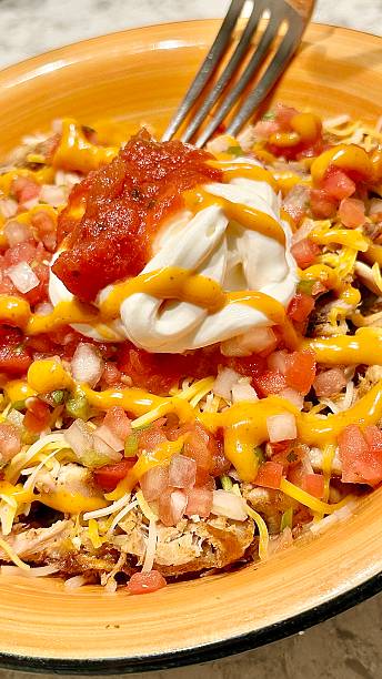 Mexican chicken and rice bowl with black beans, pico de gillo, Mexican cheese, sour cream and salsa.