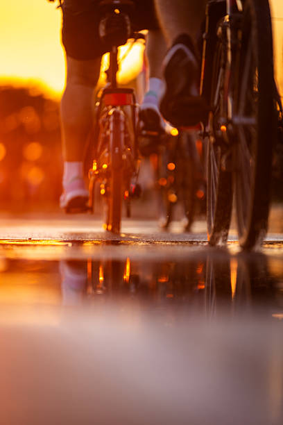 Blurred motion of cyclists riding at night, vibrant energy, colorful lights, dynamic movement of the bustling street scene