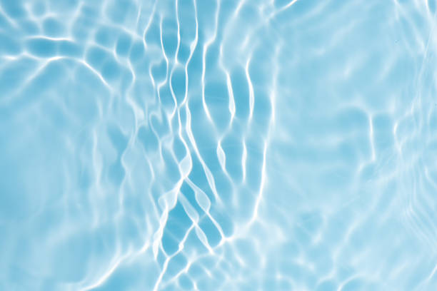 istock Blue water with ripples on the surface. Defocus blurred transparent blue colored clear calm water surface texture with splashes and bubbles. Water waves with shining pattern texture background. 2224349138